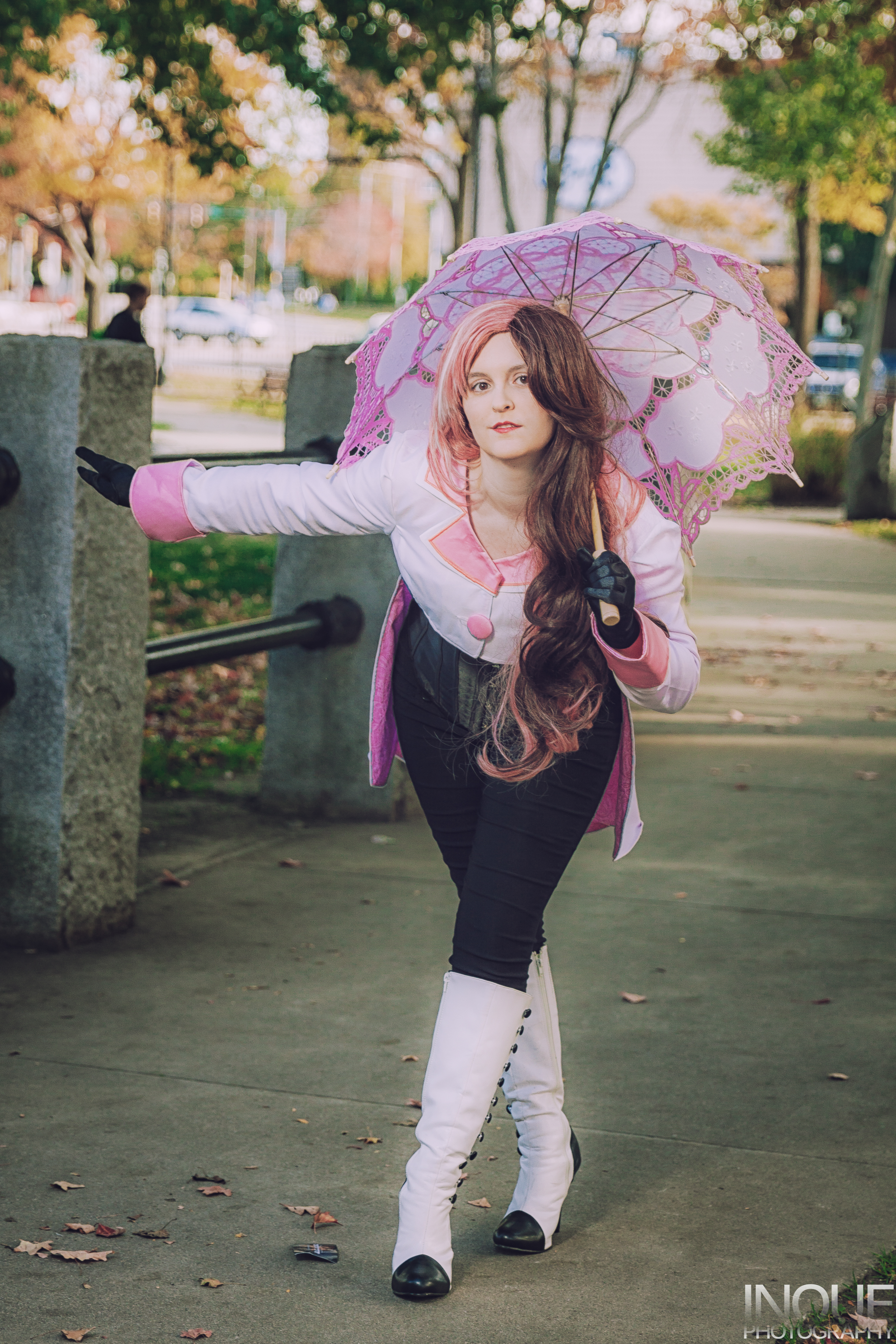 Neo bowing with arm out, holding a parasol.