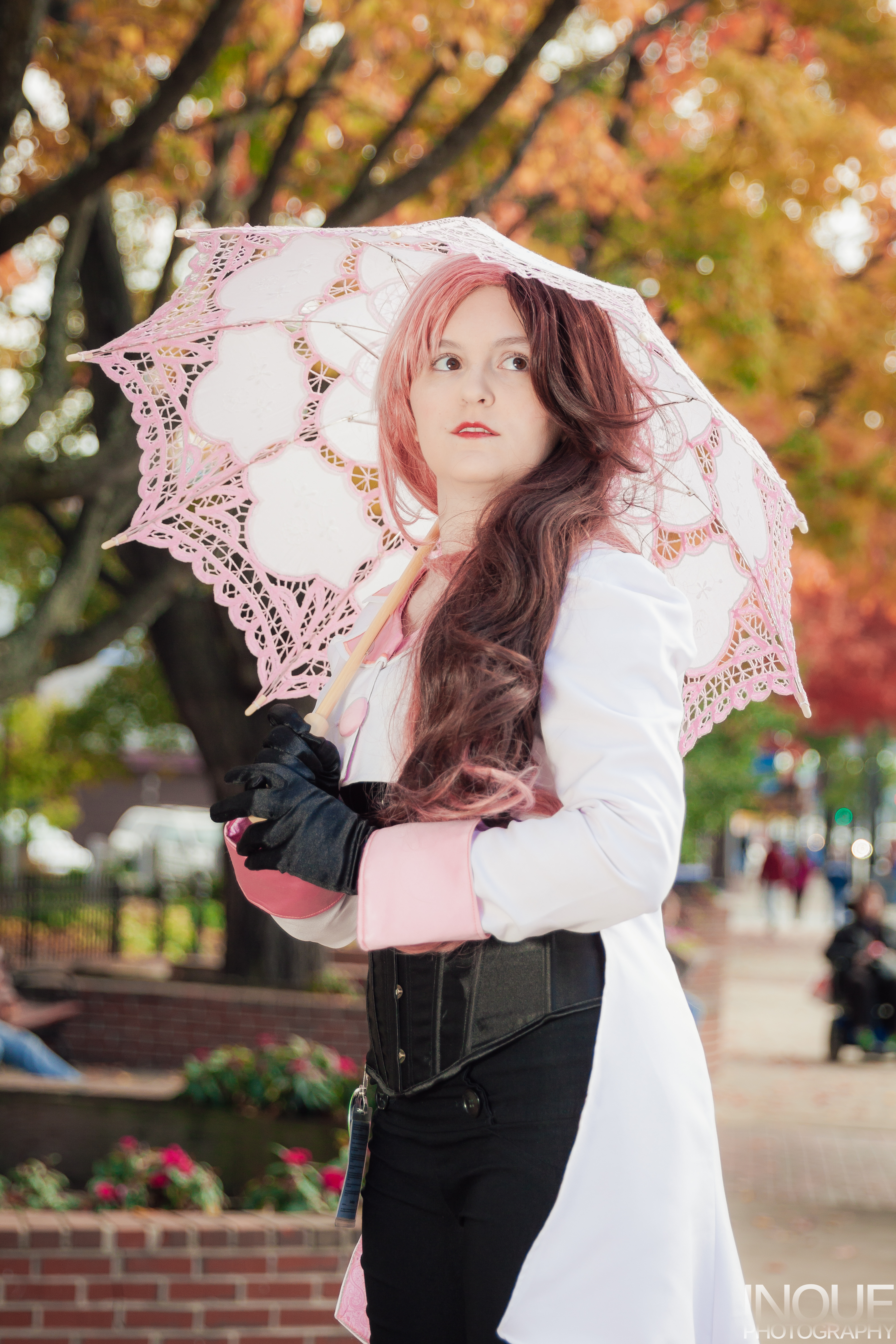 Neo looking off to the side, holding a parasol over shoulder.