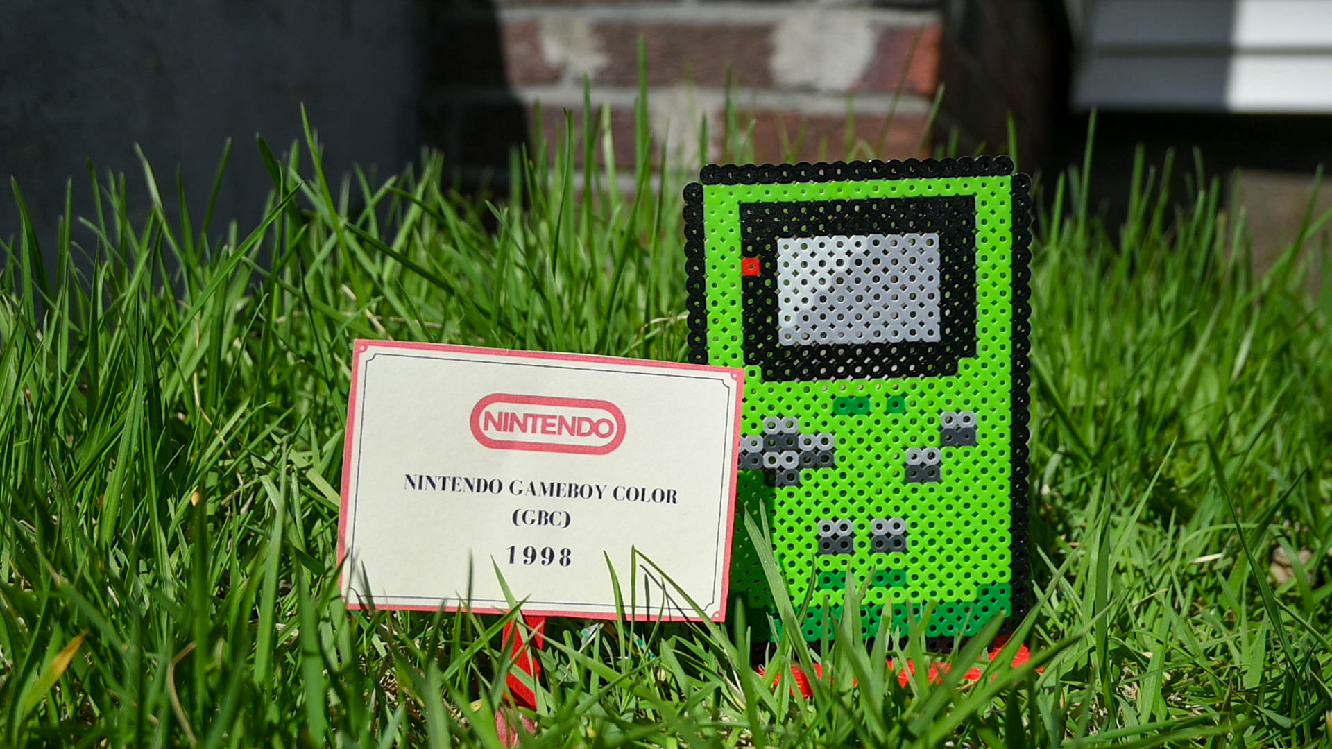 Green Gameboy Color made out of perler fuse beads.