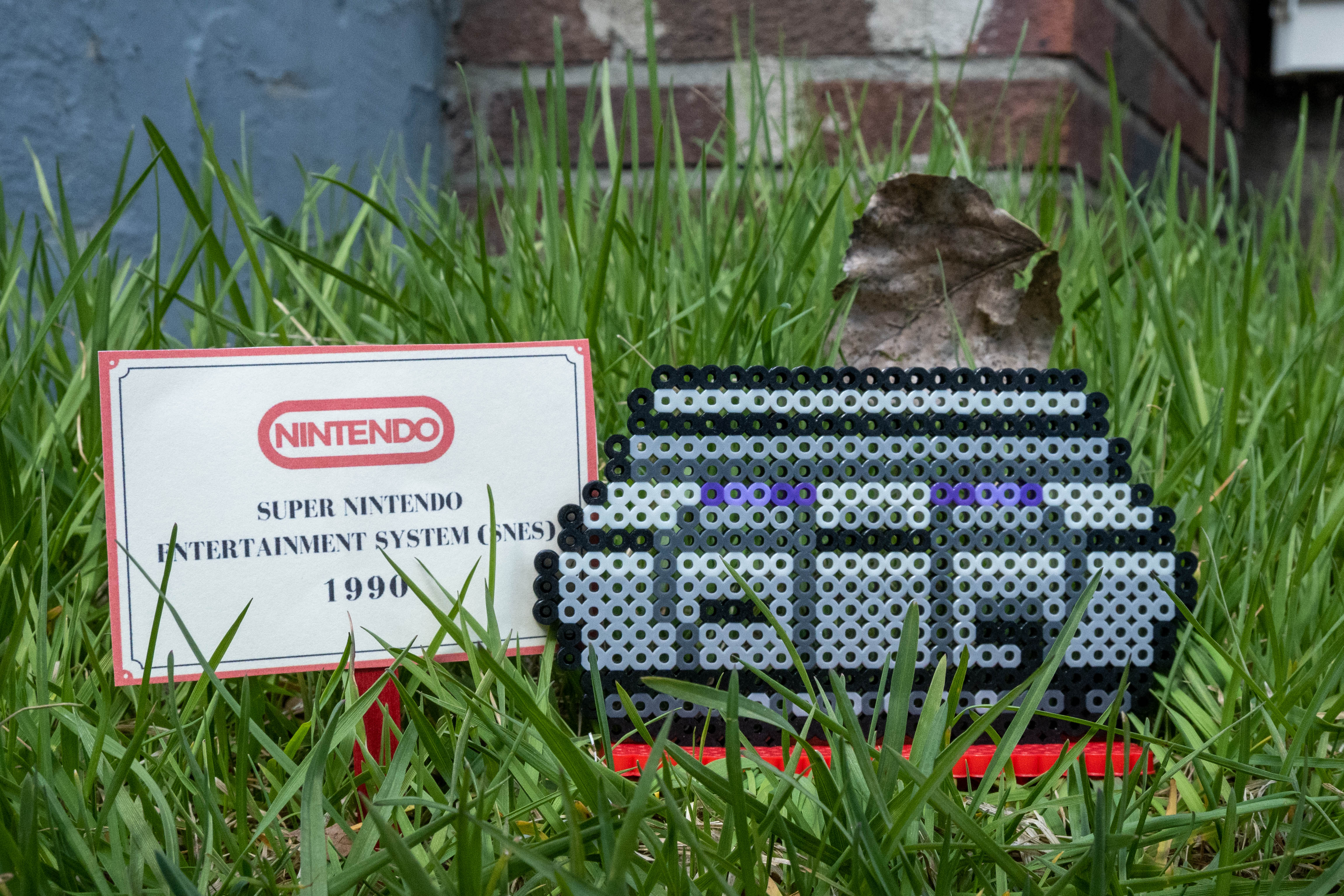 Grey Super Nintendo console made out of Perler brand fuse beads.